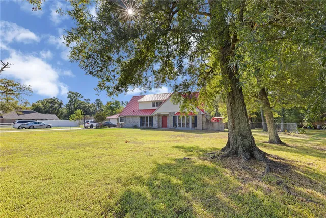 a view of a house with pool and a yard