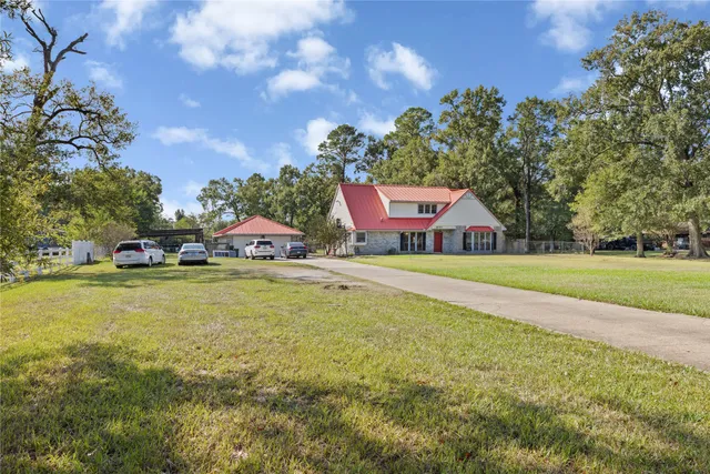a sign that is sitting in the middle of a big yard