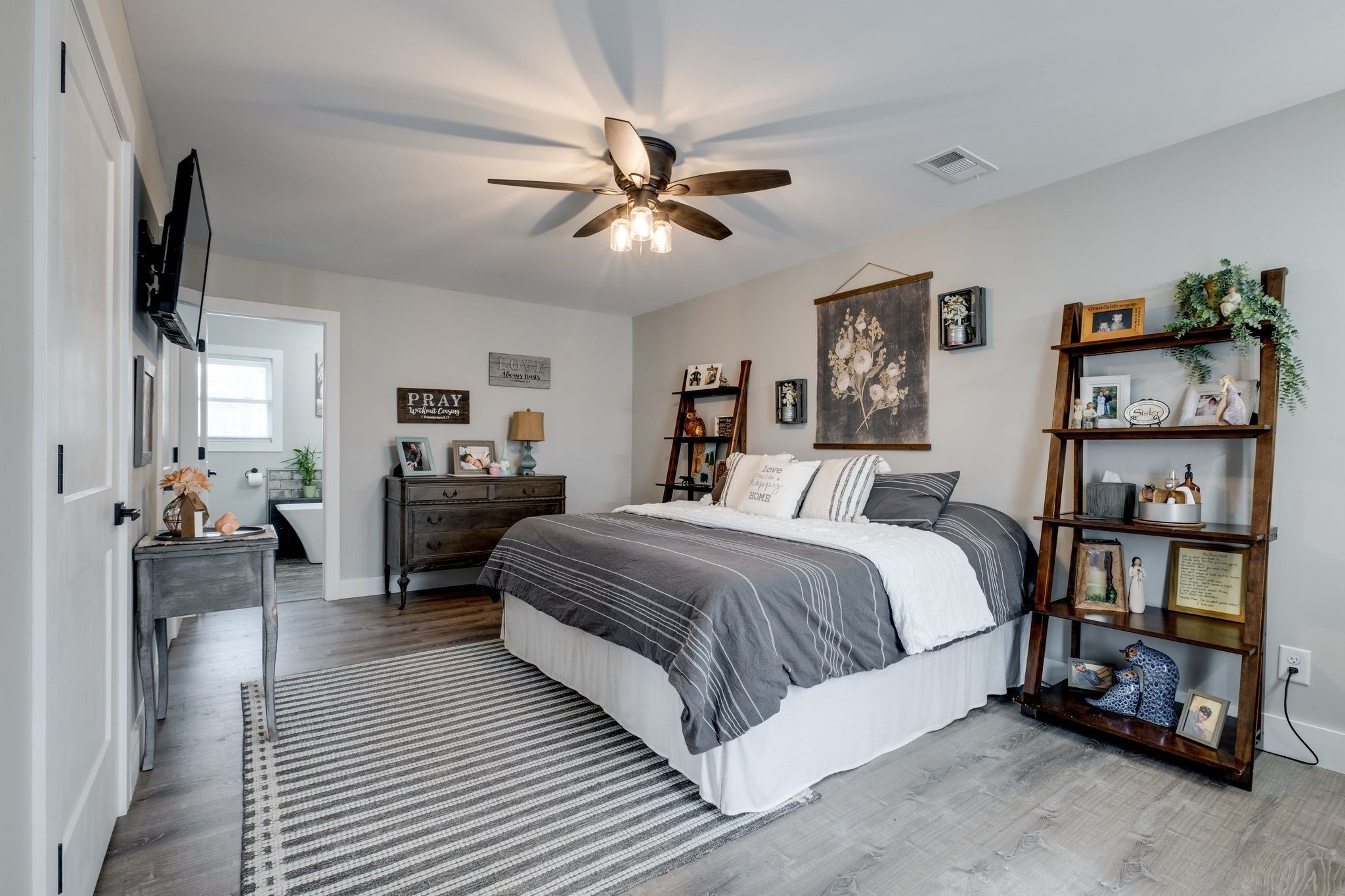 1043 Murphy Hollow Road Vanleer, TN 37181 - Photo 24 of 68 a spacious bedroom with a bed and a chandelier