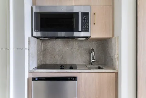 a spacious bedroom with a bed and a flat screen tv