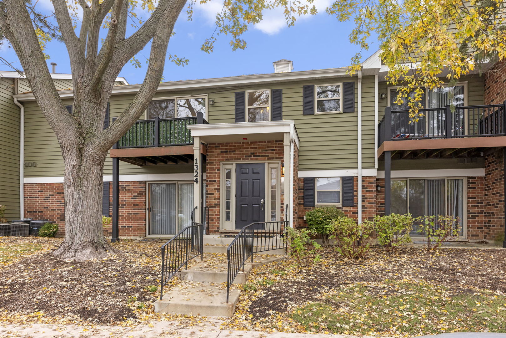 1324 McDowell Road, Unit 104 Naperville, IL 60563 - Photo 1 of 20 a front view of a house with garden