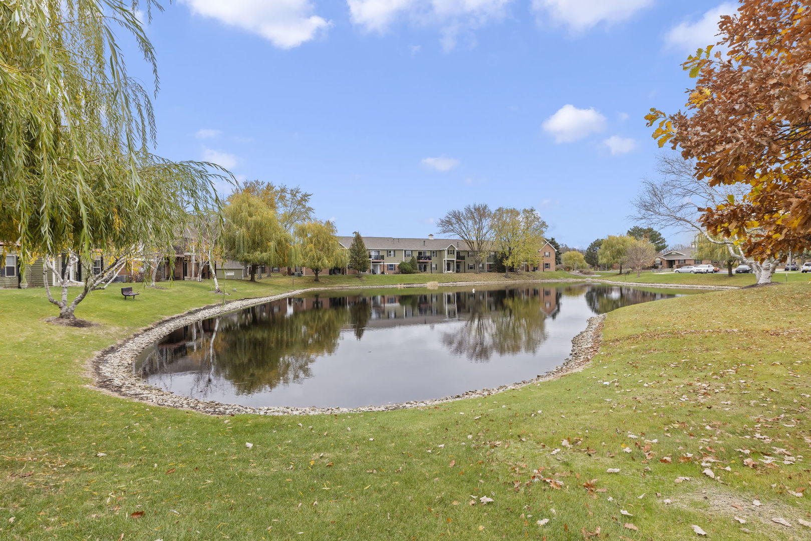 1324 McDowell Road, Unit 104 Naperville, IL 60563 - Photo 19 of 20 a view of a lake with a yard