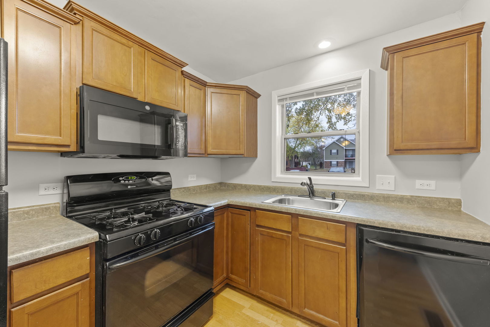 1324 McDowell Road, Unit 104 Naperville, IL 60563 - Photo 7 of 20 a kitchen with stainless steel appliances a sink stove and microwave
