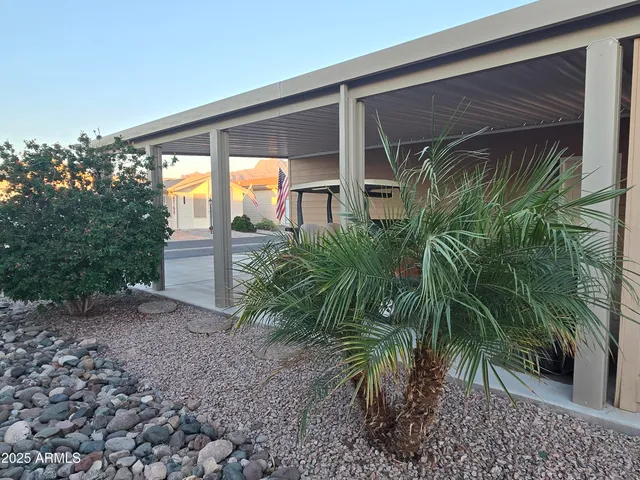 a kitchen with stainless steel appliances a refrigerator a stove a sink a dining table and chairs