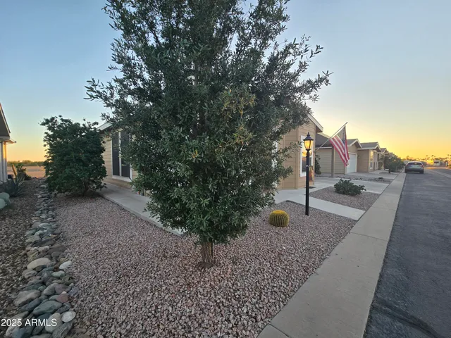 a kitchen with stainless steel appliances granite countertop a table chairs refrigerator and sink