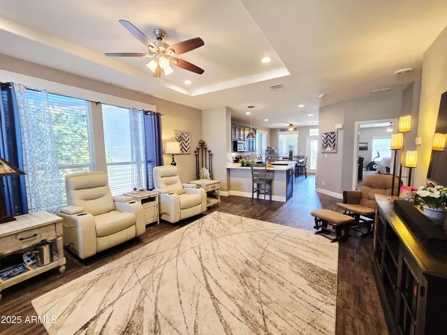 a kitchen with a refrigerator a stove top oven a sink dishwasher and wooden cabinets with wooden floor