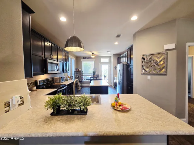 a bathroom with a sink a toilet a mirror and shower curtain