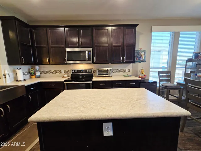 a front view of a house with a yard and trees