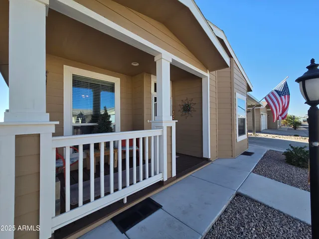 a view of a patio with table and chairs with wooden fence