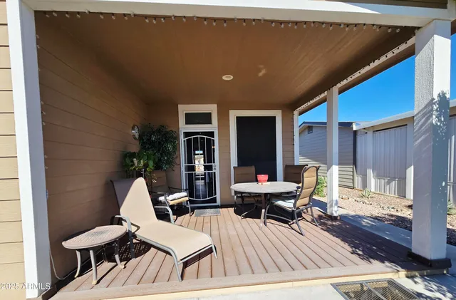 a balcony with furniture and wooden floor