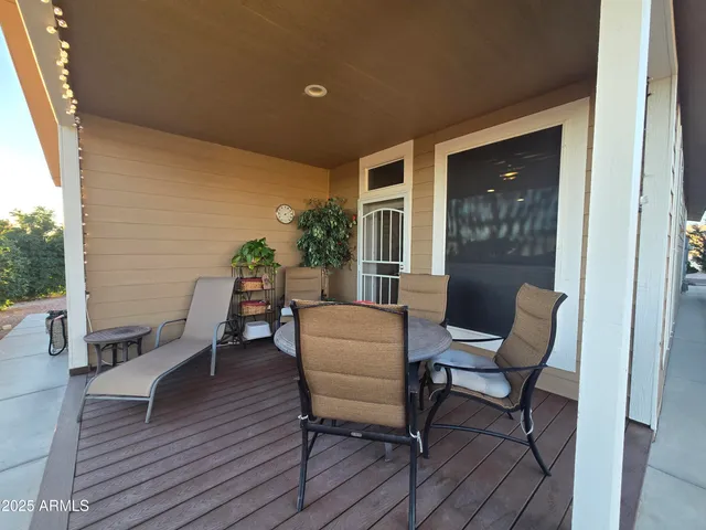 a balcony with table and chairs