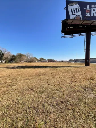 a view of a field with an ocean view