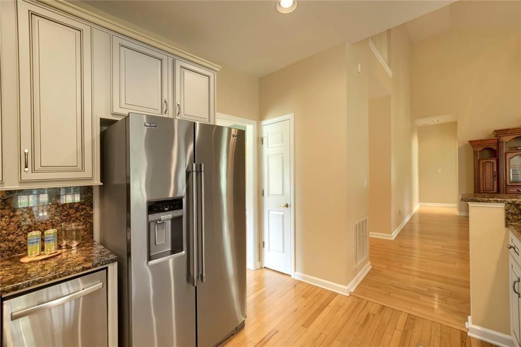 3413 Doe's Court Villa Rica, GA 30180 - Photo 15 of 37 a kitchen with stainless steel appliances granite countertop a refrigerator and a stove top oven