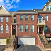 a front view of a residential apartment building with a yard