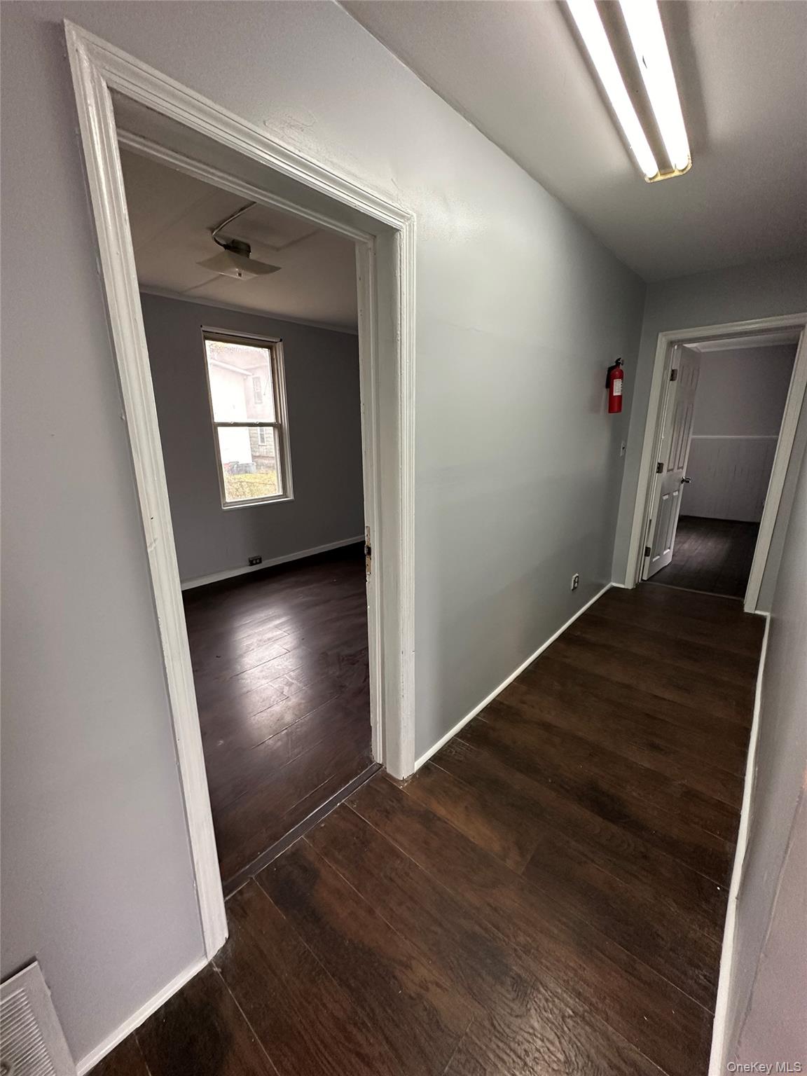 39 Spruce Street Poughkeepsie, NY 12601 - Photo 4 of 11 an empty room with wooden floor and windows