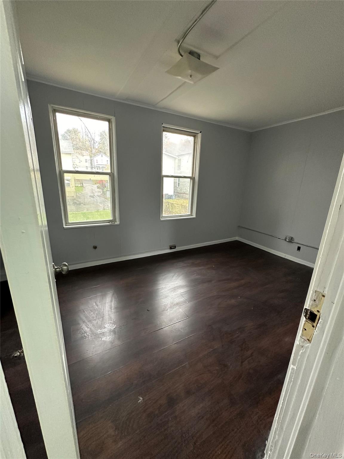 39 Spruce Street Poughkeepsie, NY 12601 - Photo 5 of 11 an empty room with wooden floor and windows