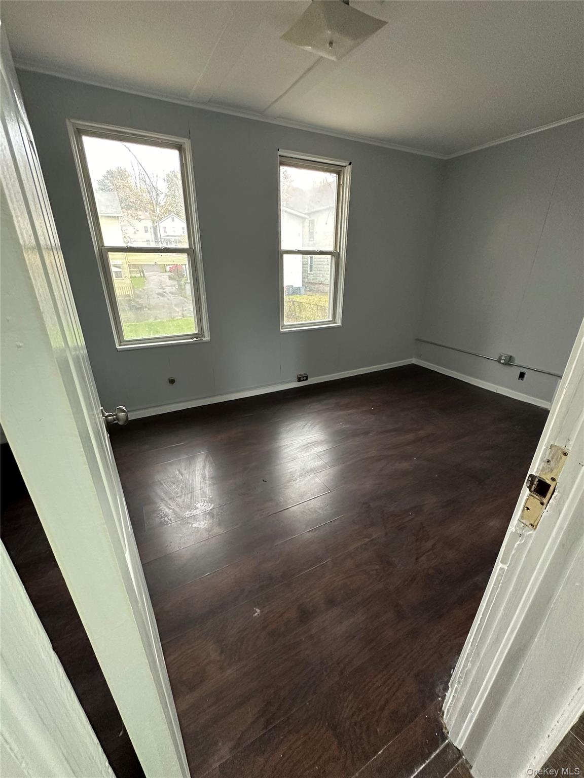 39 Spruce Street Poughkeepsie, NY 12601 - Photo 6 of 11 en empty room with wooden floor and windows