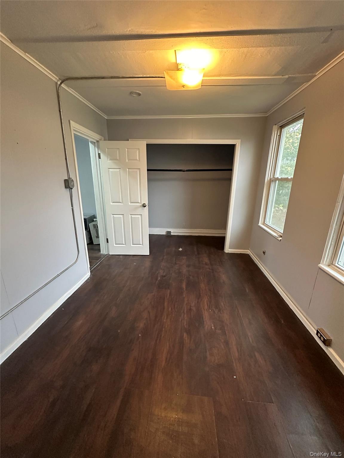 39 Spruce Street Poughkeepsie, NY 12601 - Photo 8 of 11 an empty room with wooden floor and windows
