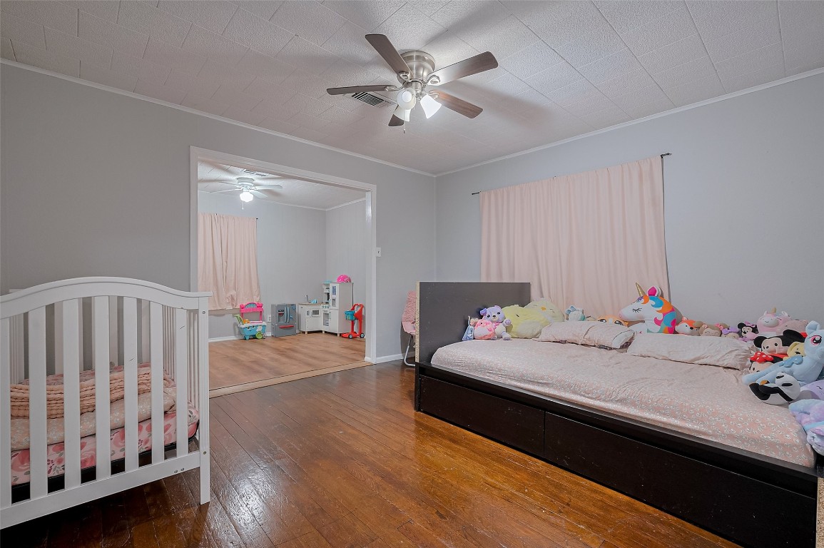 16128 1/2 Ridlon Street Channelview, TX 77530 - Photo 20 of 43 This secondary bedroom expands into an adjoining bonus space—perfect for a playroom or creative space. Both areas feature ceiling fans for added comfort.