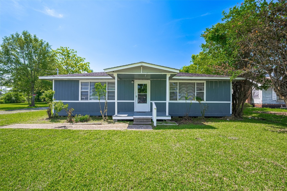 16128 1/2 Ridlon Street Channelview, TX 77530 - Photo 27 of 43 The second house mirrors the charm of the first with blue siding and crisp white trim. An elevated porch adds character and a welcoming entry point.