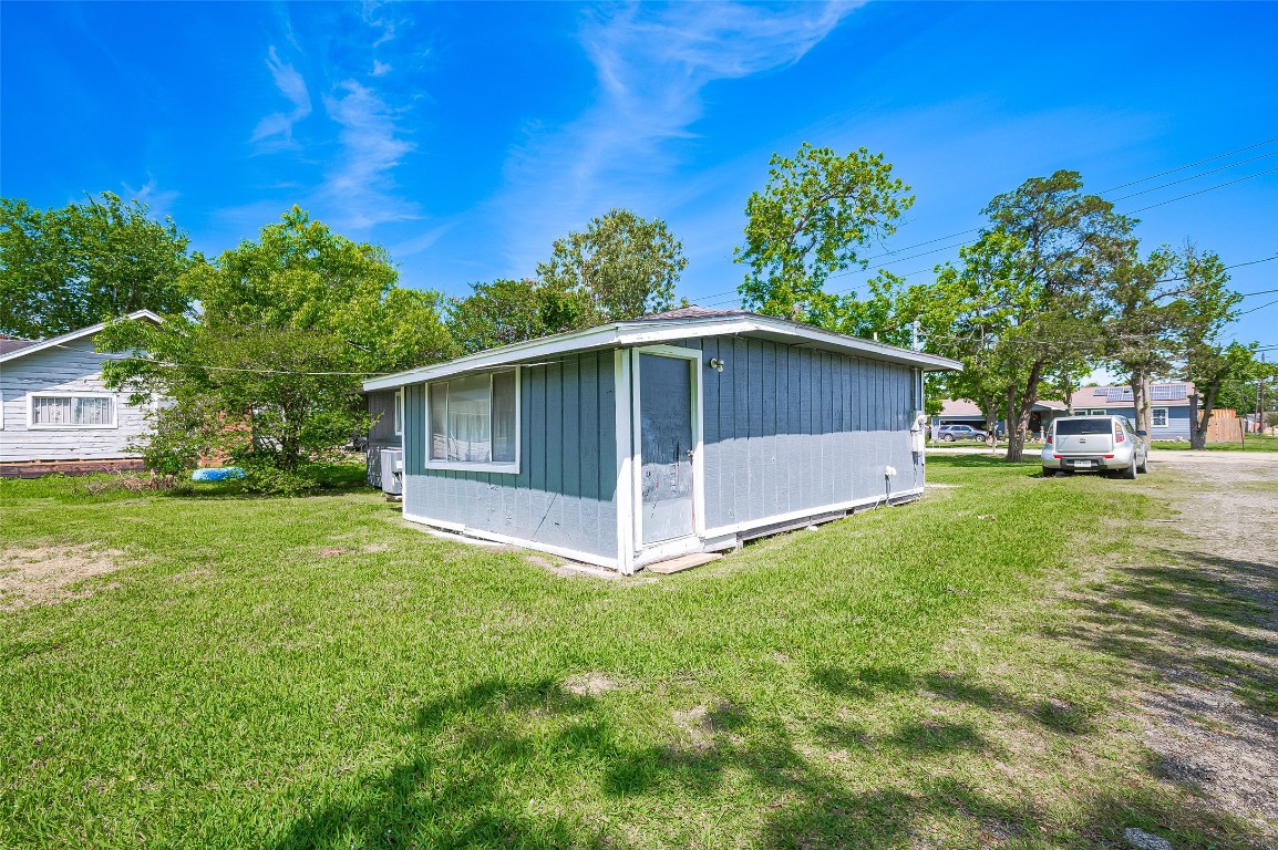 16128 1/2 Ridlon Street Channelview, TX 77530 - Photo 29 of 43 Behind the home, lush grass stretches out—offering a perfect canvas for outdoor gatherings, gardens, or recreational space.