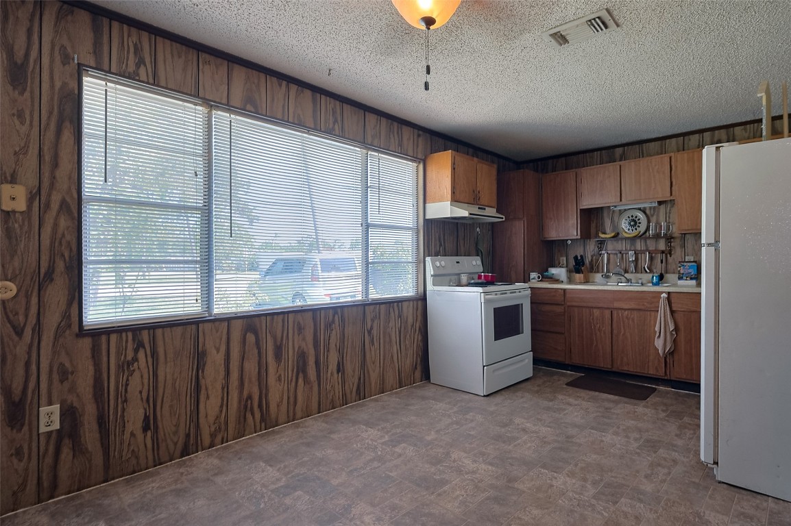 16128 1/2 Ridlon Street Channelview, TX 77530 - Photo 32 of 43 The kitchen's spacious layout can easily accommodate a dining space. A wide window brings in natural light and frames views of the greenery just outside.