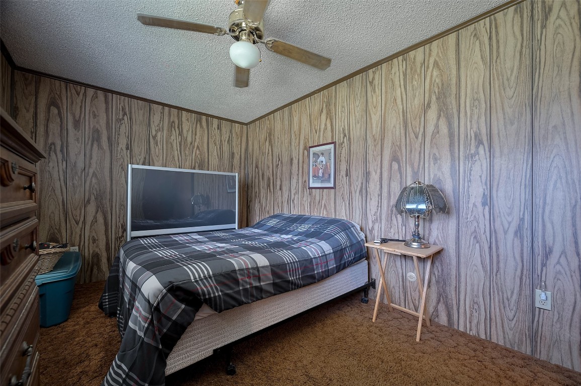 16128 1/2 Ridlon Street Channelview, TX 77530 - Photo 33 of 43 The wood-like paneling continues into this carpeted bedroom, creating a warm and restful space to end the day.