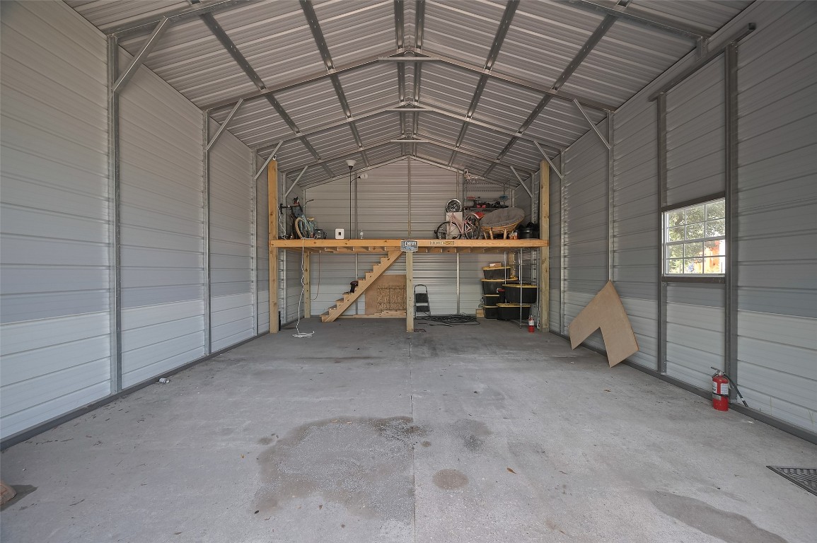 16128 1/2 Ridlon Street Channelview, TX 77530 - Photo 38 of 43 Inside the garage/workshop, the possibilities multiply. A loft area adds usable vertical space while the main floor boasts high ceilings, a window, and ample room for equipment or creativity.