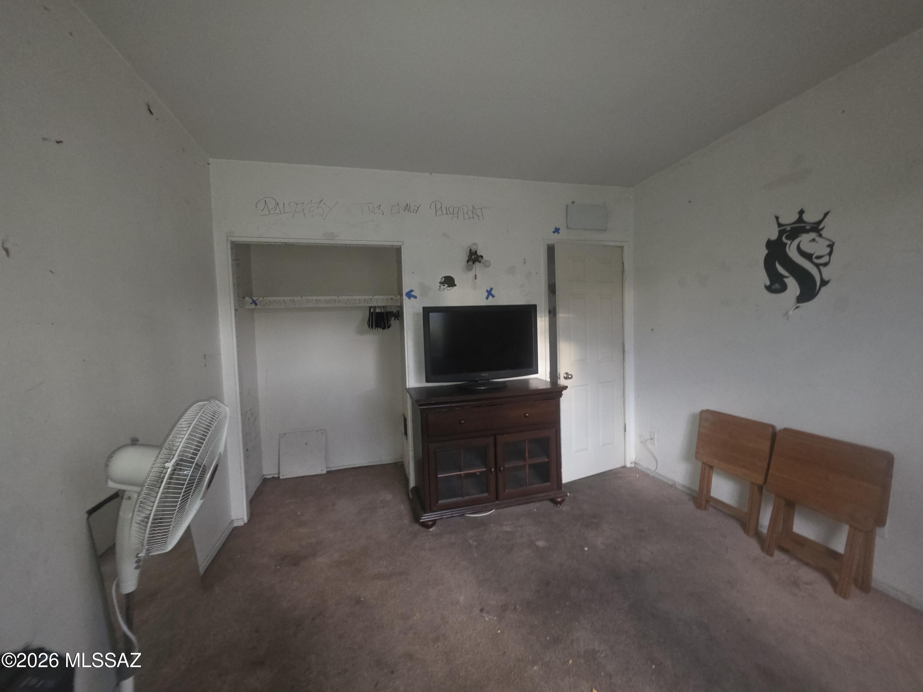 211 West Roger Road, Unit 24 Tucson, AZ 85705 - Photo 13 of 24 a living room with furniture and a flat screen tv