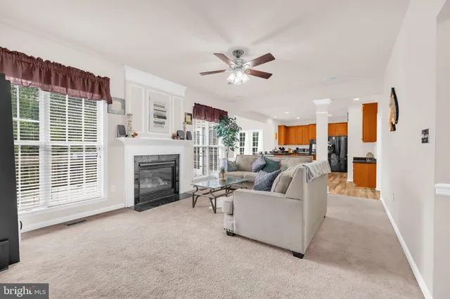 a large kitchen with granite countertop a large window and stainless steel appliances
