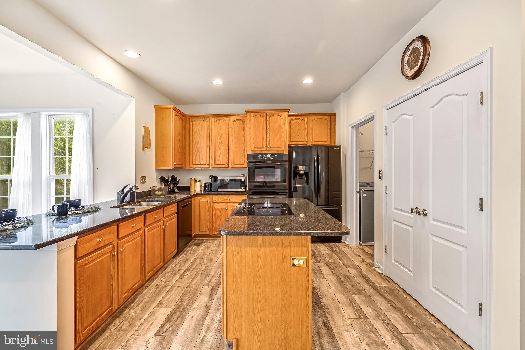12 Evan Court Brunswick, MD 21758 - Photo 15 of 39 a large kitchen with granite countertop a large window and stainless steel appliances