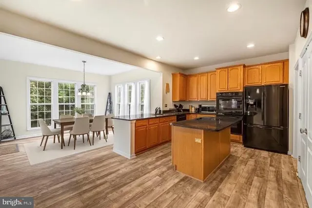 a view of a dining room with furniture large windows and wooden floor