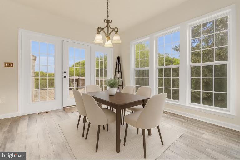 12 Evan Court Brunswick, MD 21758 - Photo 17 of 39 a view of a dining room with furniture large windows and wooden floor