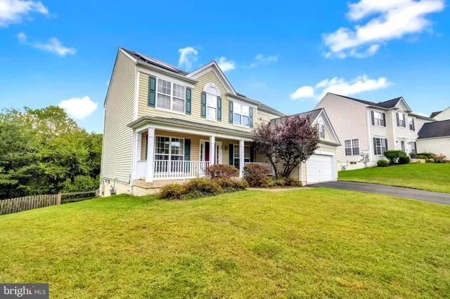 a view of a house with a big yard and potted plants
