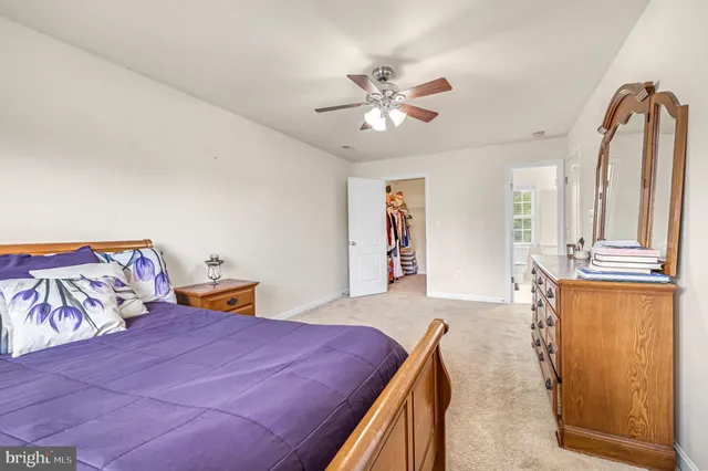 a view of walk in closet with clothes