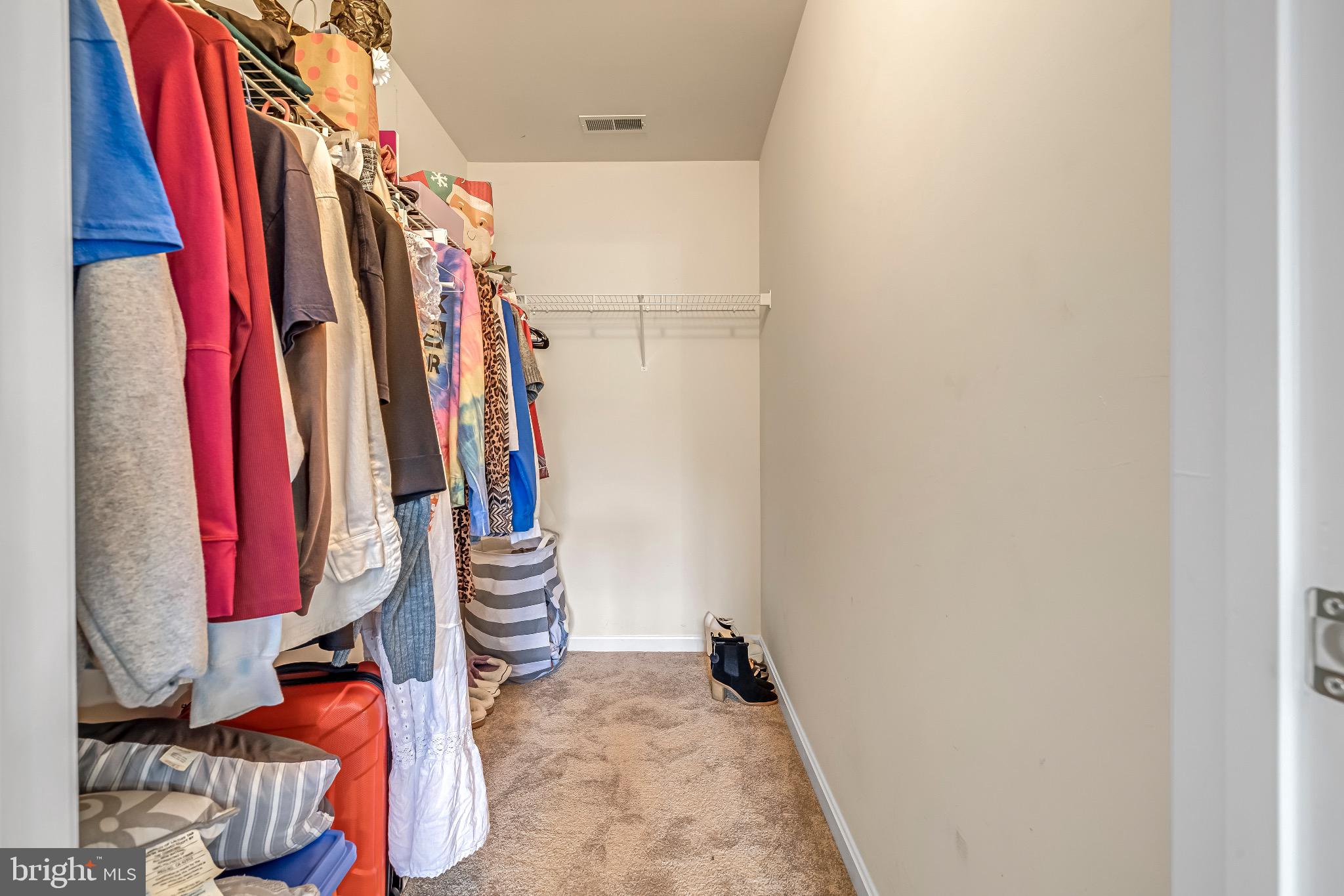 12 Evan Court Brunswick, MD 21758 - Photo 23 of 39 a view of walk in closet with clothes