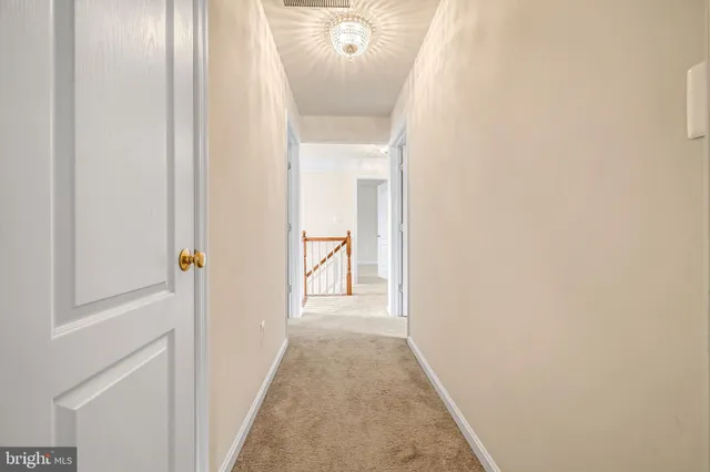 a bedroom with a large bed a couch and a chandelier