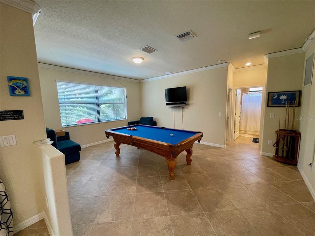 20940 Valore Court Venice, FL 34293 - Photo 12 of 52 a living room with furniture and a flat screen tv