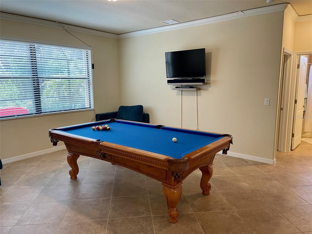 20940 Valore Court Venice, FL 34293 - Photo 13 of 52 a room with furniture pool table and flat screen tv