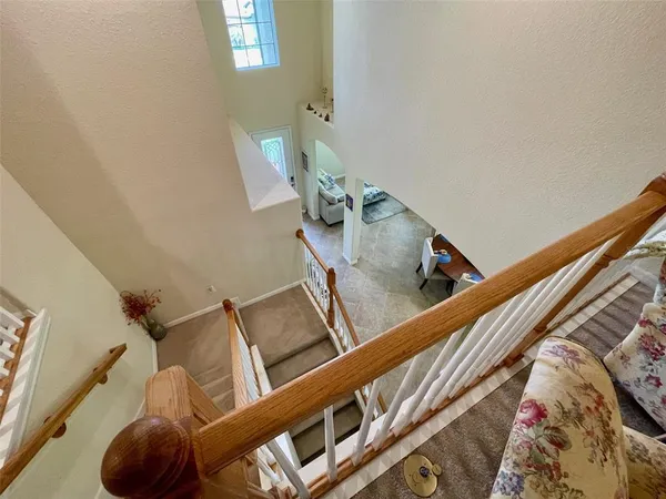 a view of a hallway with furniture and stairs