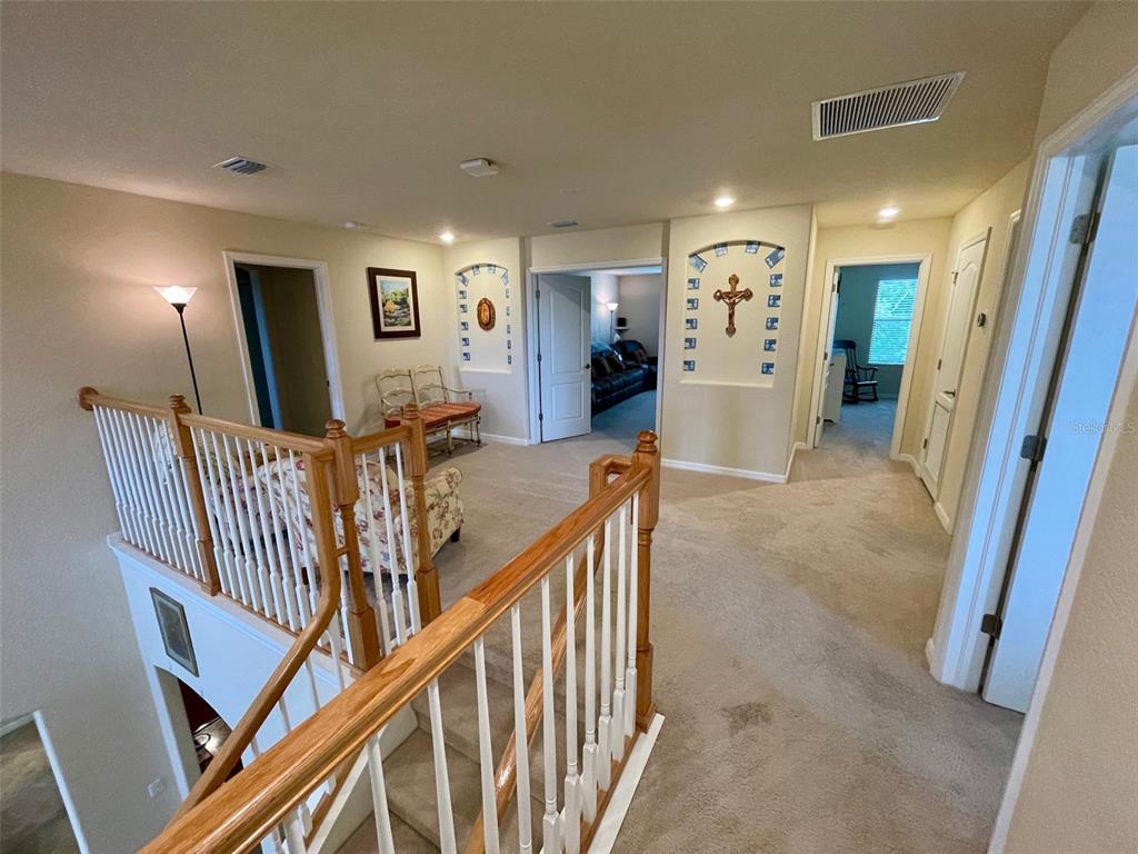 20940 Valore Court Venice, FL 34293 - Photo 15 of 52 a view of a hallway with furniture and stairs