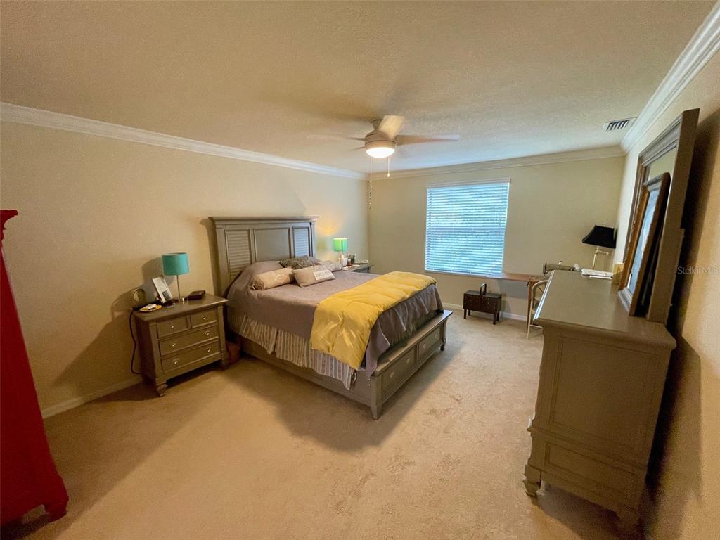 20940 Valore Court Venice, FL 34293 - Photo 18 of 52 a bedroom with a bed and a couch