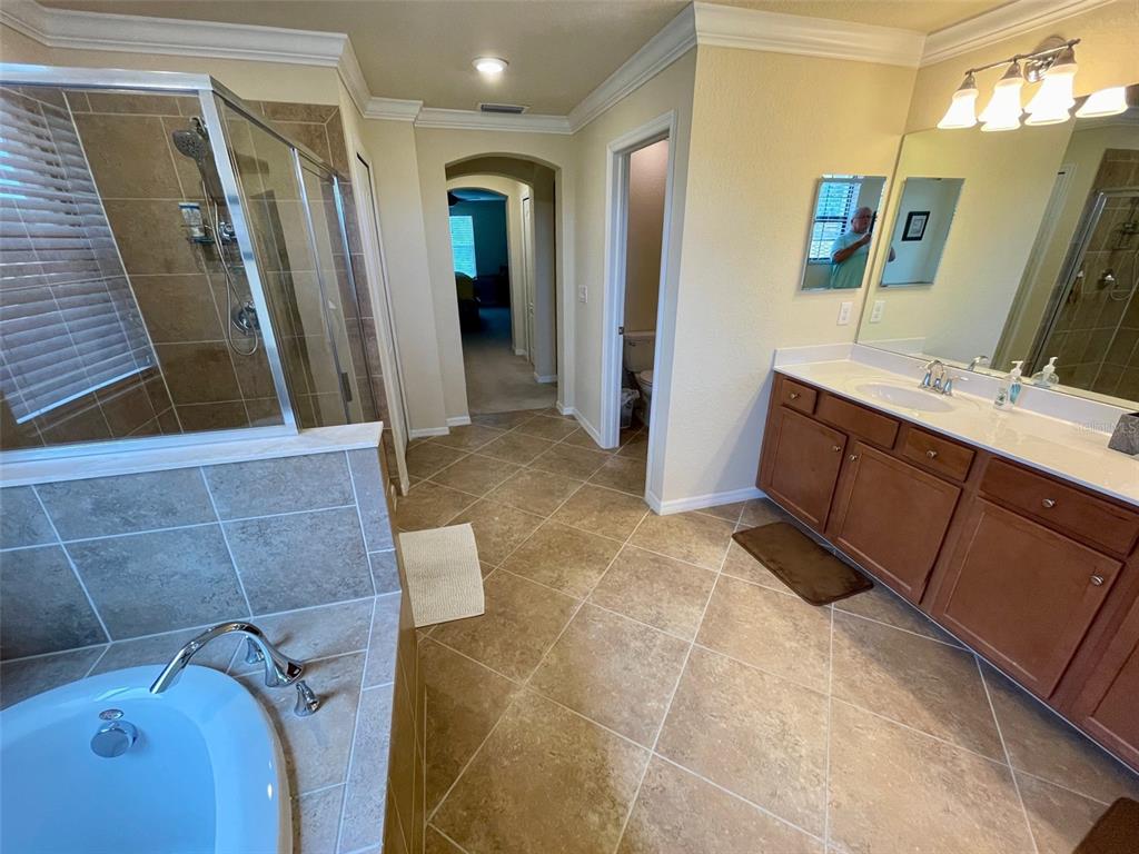 20940 Valore Court Venice, FL 34293 - Photo 20 of 52 a bathroom with a tub sink and mirror