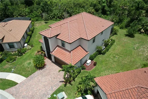 an aerial view of a house with garden space and a house