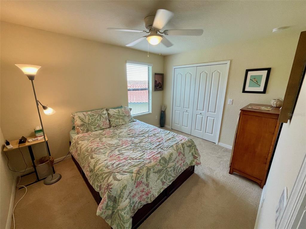 20940 Valore Court Venice, FL 34293 - Photo 22 of 52 a bedroom with a bed and a chandelier