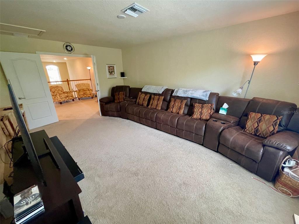 20940 Valore Court Venice, FL 34293 - Photo 25 of 52 a living room with furniture and a flat screen tv
