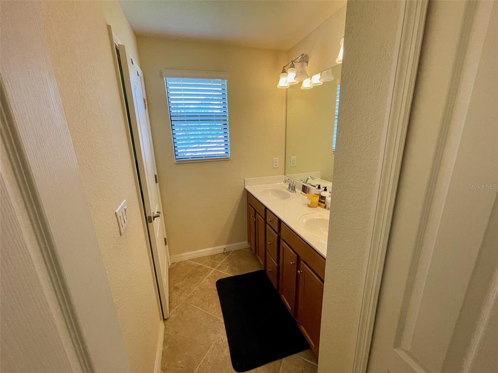 20940 Valore Court Venice, FL 34293 - Photo 26 of 52 a bathroom with a sink a mirror and a shower