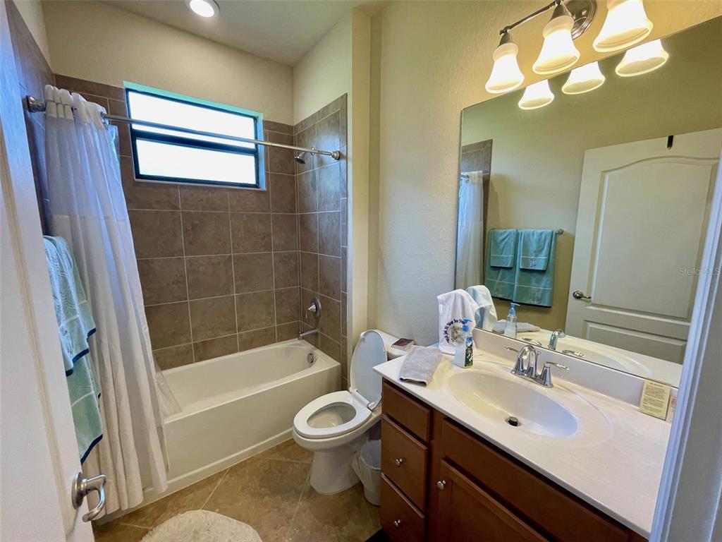 20940 Valore Court Venice, FL 34293 - Photo 27 of 52 a bathroom with a sink a toilet and shower