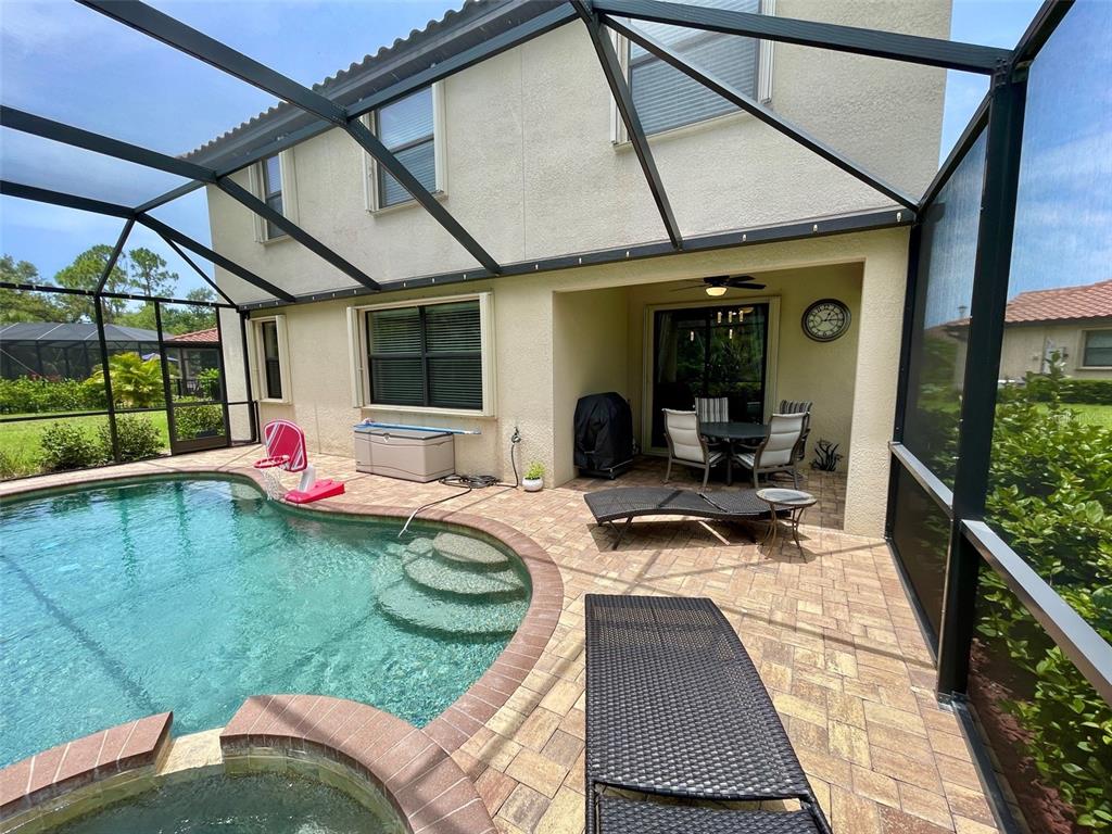 20940 Valore Court Venice, FL 34293 - Photo 35 of 52 a view of swimming pool with a lounge chairs in a patio