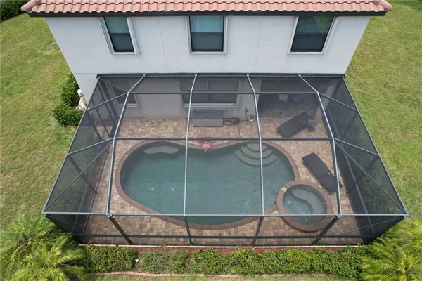 an aerial view of residential house with outdoor space and swimming pool
